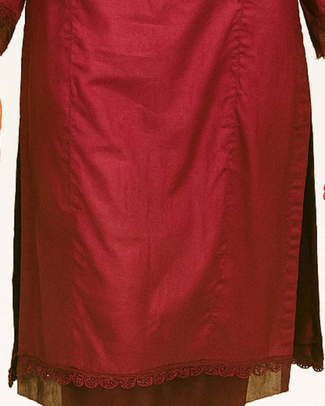 Close-up of a maroon shirt with lace work stitched party wear dress