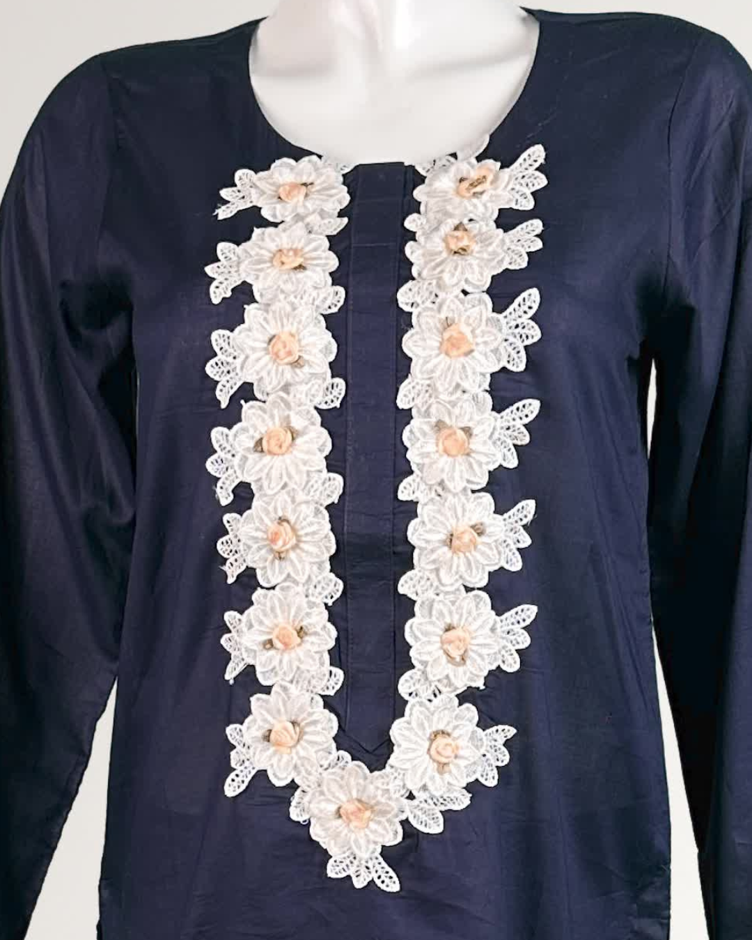 showing a Navy blue trendy women's office wear with white floral lace detailing on neckline 