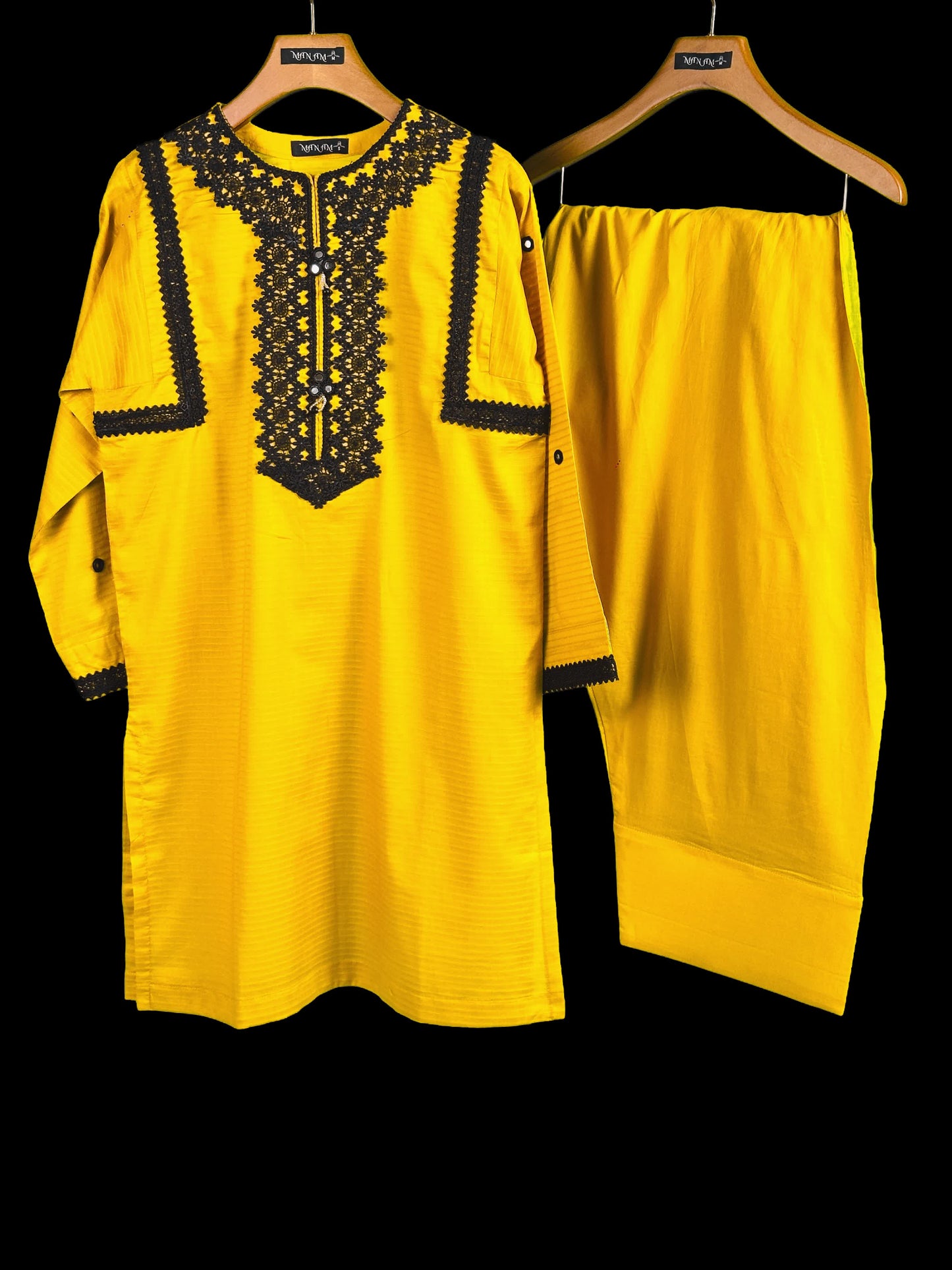 display new summer collection best dresses yellow lace embroidered kurta with matching farshi shalwar on hangers against a black background