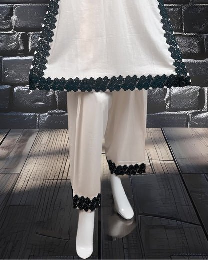  wearing a white dress with black lace work along with farshi shalwar.